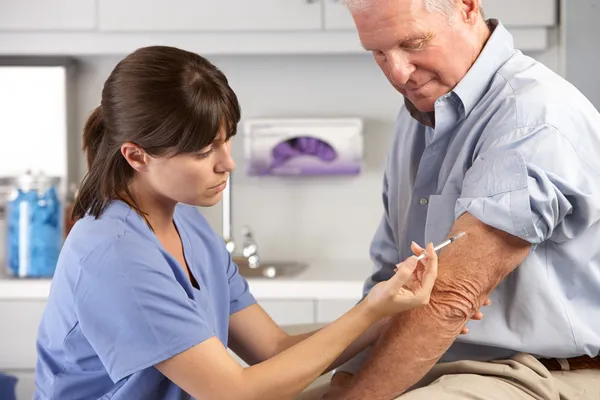 depositphotos 24655019 stock photo doctor giving male patient injection